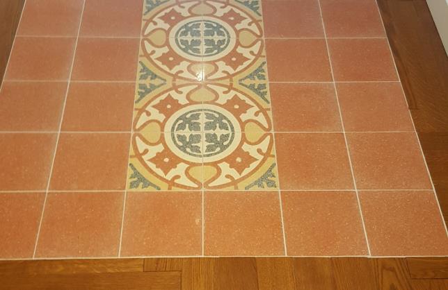 Carpet of cement tiles with hardwood floors